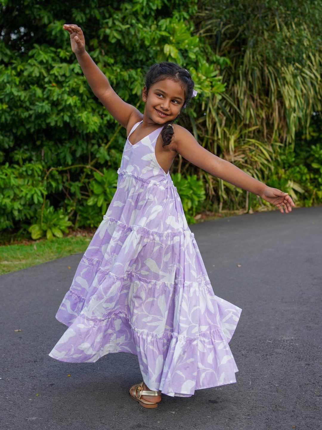 Girls lavender long dress in sustainable cotton with sleeveless design and flowing skirt.
