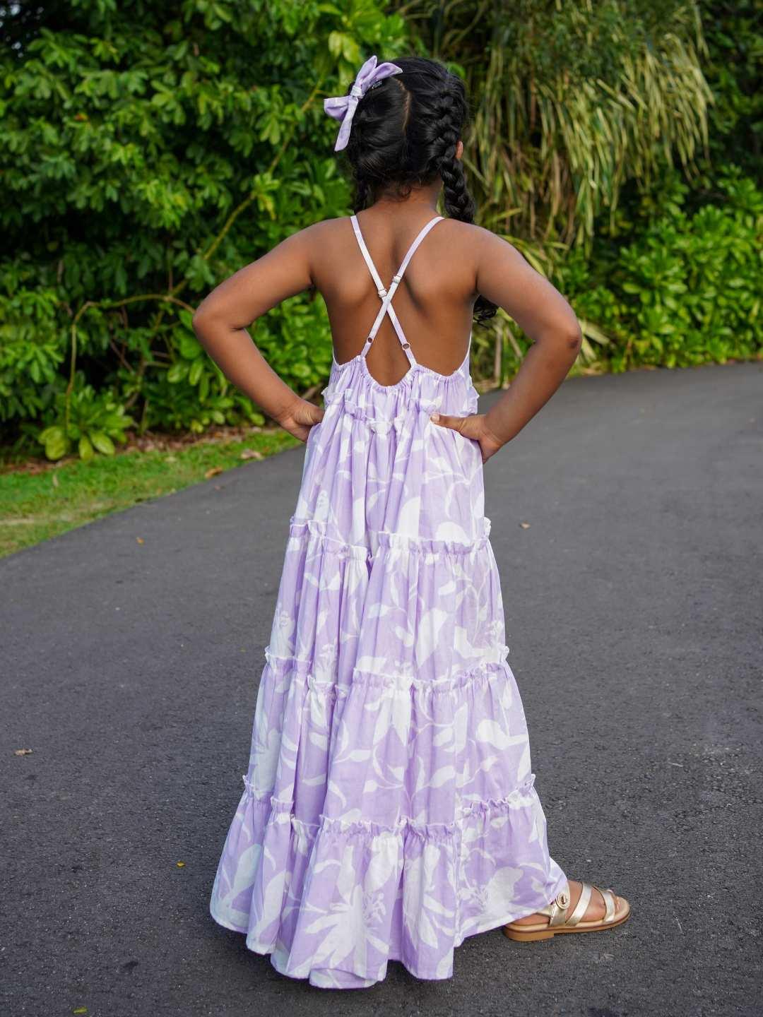 Girls lavender cotton long dress with tiered skirt, crisscross back straps, and sustainable fabric.