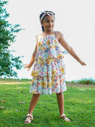Girls tiered cotton dress in spring floral print with ruffled straps, sustainable and lightweight for casual wear.