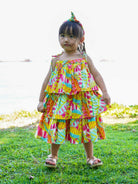 Girls tiered sundress in bright sunset print, lightweight sustainable cotton, sleeveless with ruffle layers, toddler size.