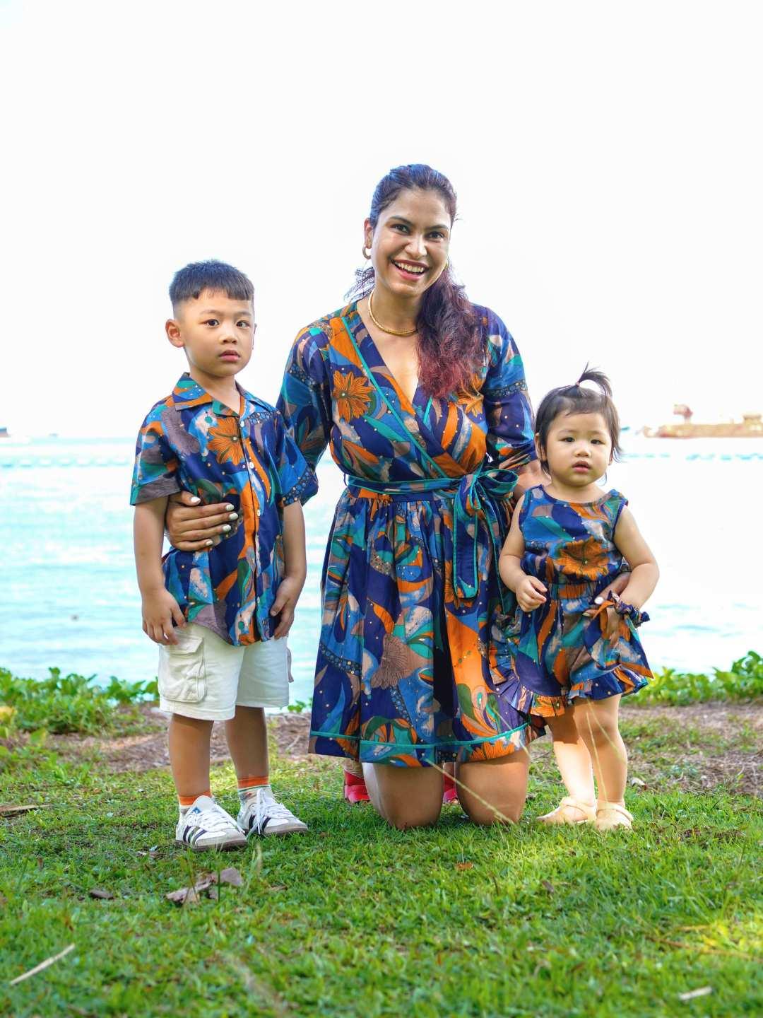 Girls sustainable cotton playsuit in blue mosaic print with short sleeves and shorts, toddler and child sizes.