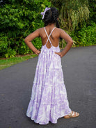 Girls lavender cotton long dress with tiered skirt, crisscross back straps, and sustainable fabric.