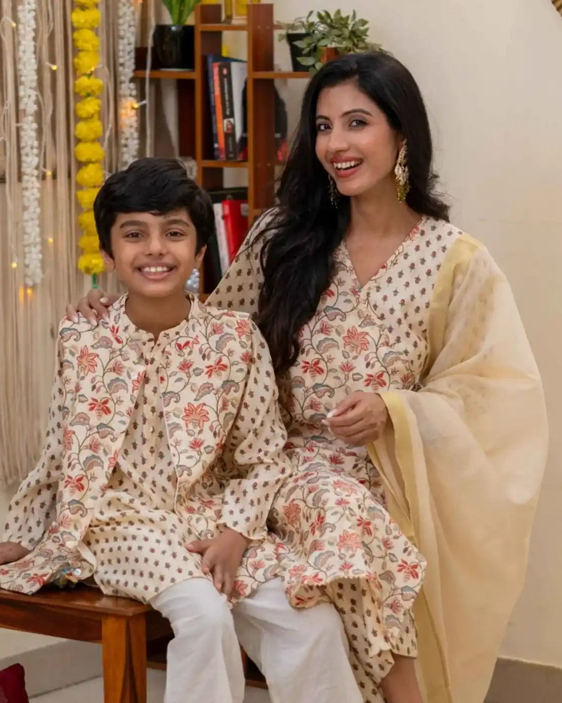 Mother and son wearing coordinated floral ethnic outfits for a festive occasion